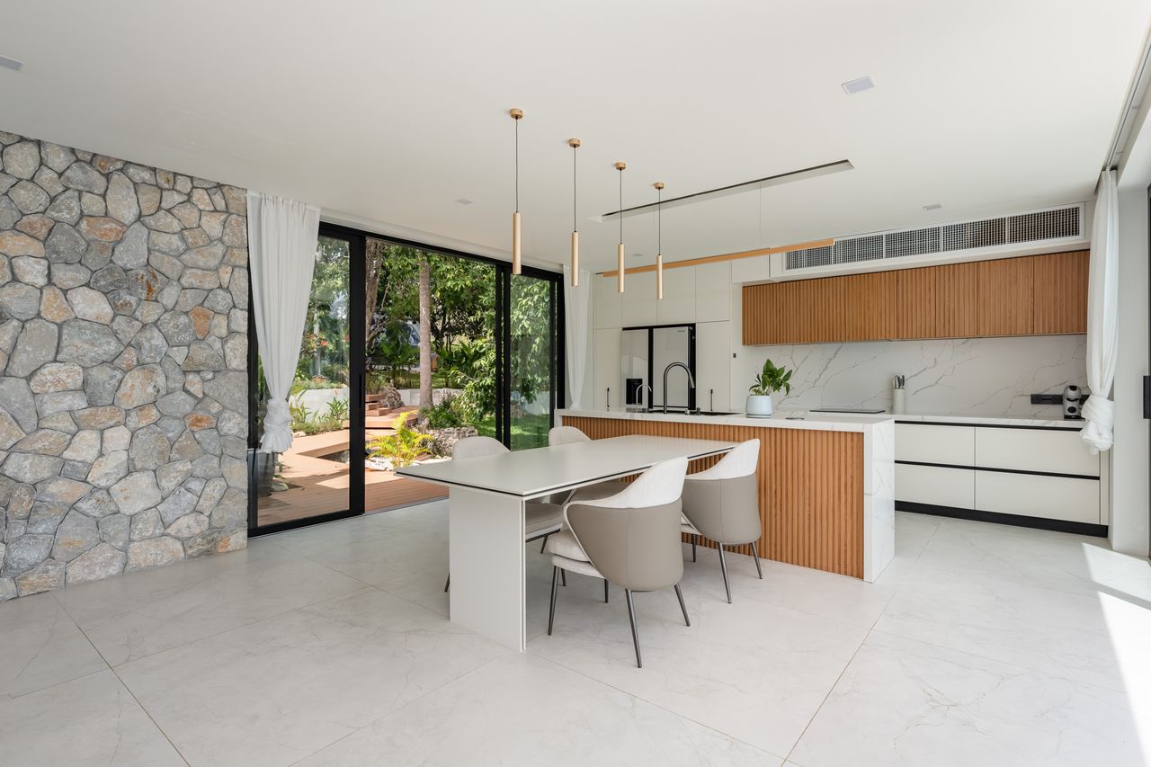 Kitchen and dining area with a stone wall