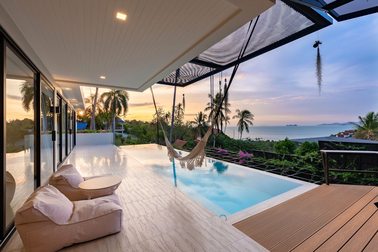 Pool deck with a hammock and the bay