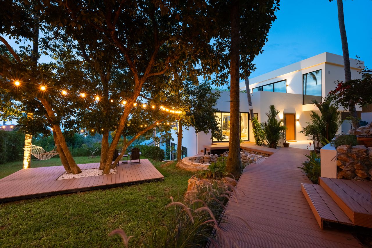 The tropical garden at dusk under string lights